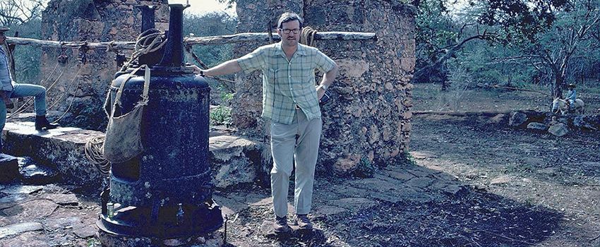 Dr. Eugene M. Wilson standing in front of a tree