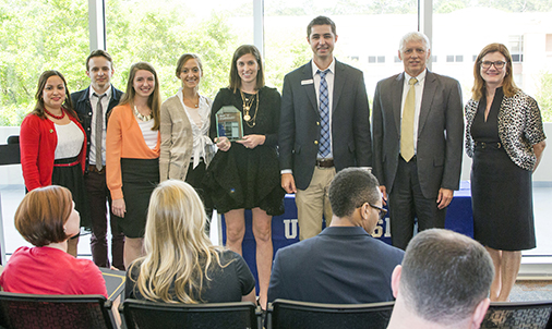 USA Communication Students and Faculty Join Protect America to Make a Difference: University of South Alabama communication student advertising agency Odd Goat wins the overall award for the best Public Relations and Advertising Campaign for the Protect America Pay it Forward Challenge. From left, Nadia Bush, USA communication instructor, Odd Goat Agency members; James Anthony Grillo, Jaclyn LeBatard, Hayley Bevel, Genie McAleer; Protect America Corporate Communications Manager Tim Krebs, USA President Dr. Tony G. Waldrop; and Dr. Patricia Mark, associate professor of communication at USA. USA is one of only three universities in the nation selected to participate in the program.