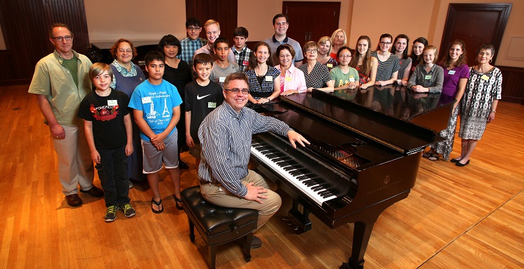 Dr. Holm is surrounded, from left, second row, by Dr. James Helton, guest professor and pianist from Ball State University, Dr. Laura Moore, associate professor of music and director of choral activities at South, and Dr. Sharon Hudson, guest professor of music from the University of Mobile,  along with the piano camp attendees ages 12-adult.