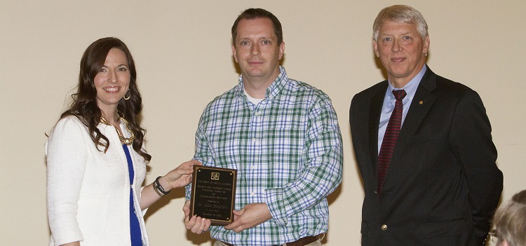 Dr. Glen Borchert, center, assistant professor of biology, accepts the 2013-2014 Semoon and Youngshin Chang Endowed Award for Humanitarian Services from, left, Dr. Julie Estis, president of the USA Faculty Senate, and, right, University President Dr. Tony Waldrop.