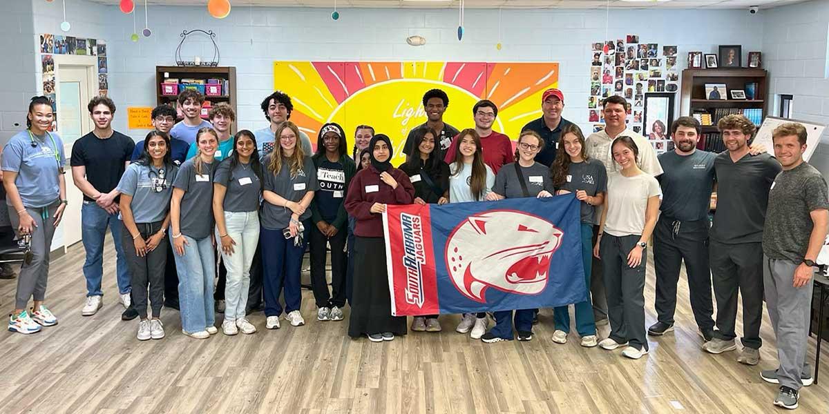 AED group image holding jag flag.