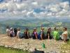 Study Abroad students sitting on a cliff looking out at the mountains