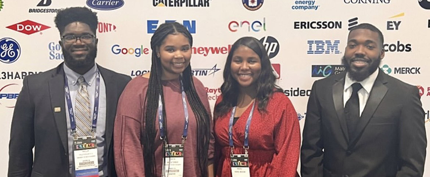 Students at event in front of BCA Partners backdrop.