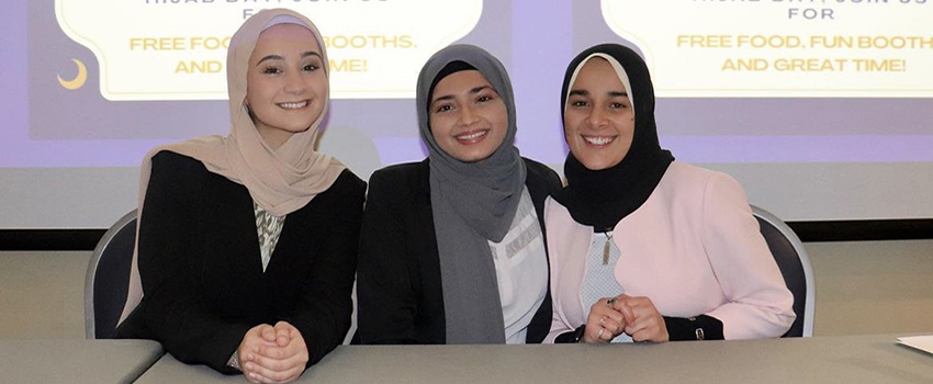 Three students in Student Center Ballroom at the event Hot Take on the Hijab.