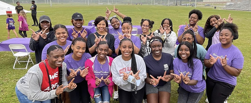 Sorority members at event on intramural field.