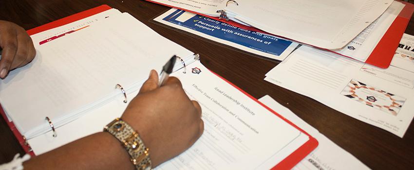 Person writing in a folder