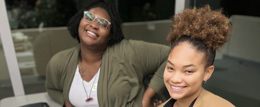 Two students smiling at Ilead event.