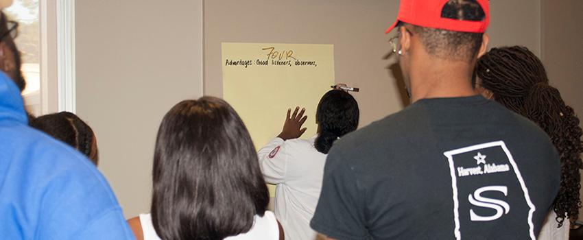 Person writing on paper on wall
