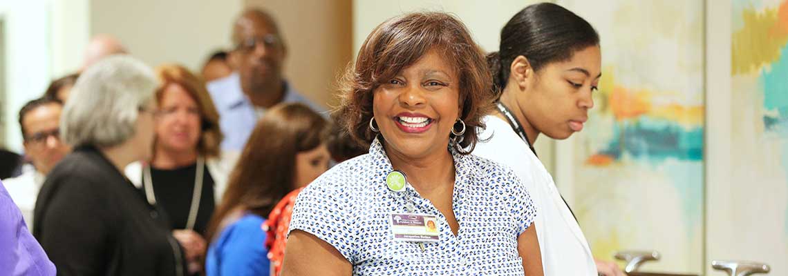 Woman smiling standing in line at Christee Miree breakfast