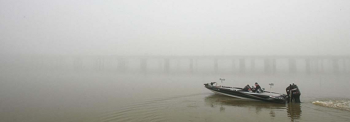 Boat in water with fog