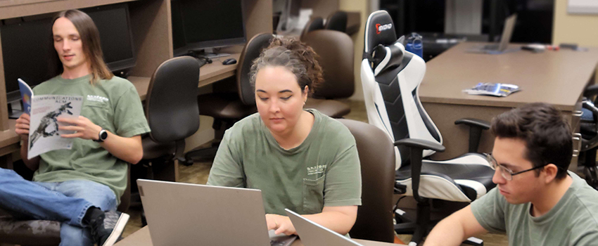 Students working in classroom on laptops.