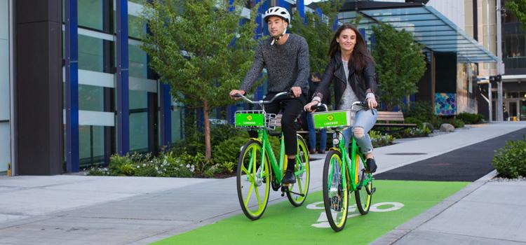 Two people riding bikes