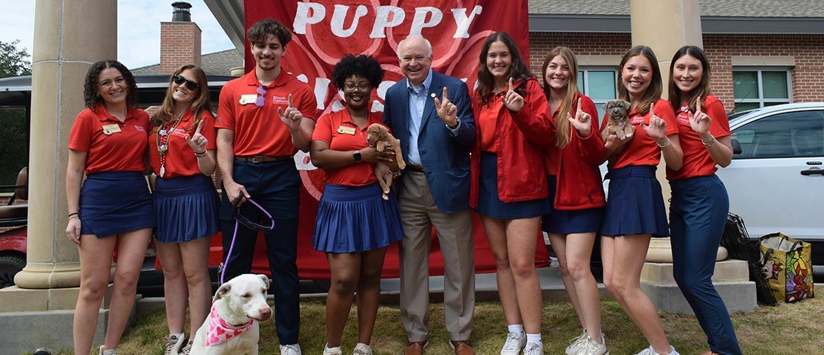 Southerners with President Bonner at puppy event.