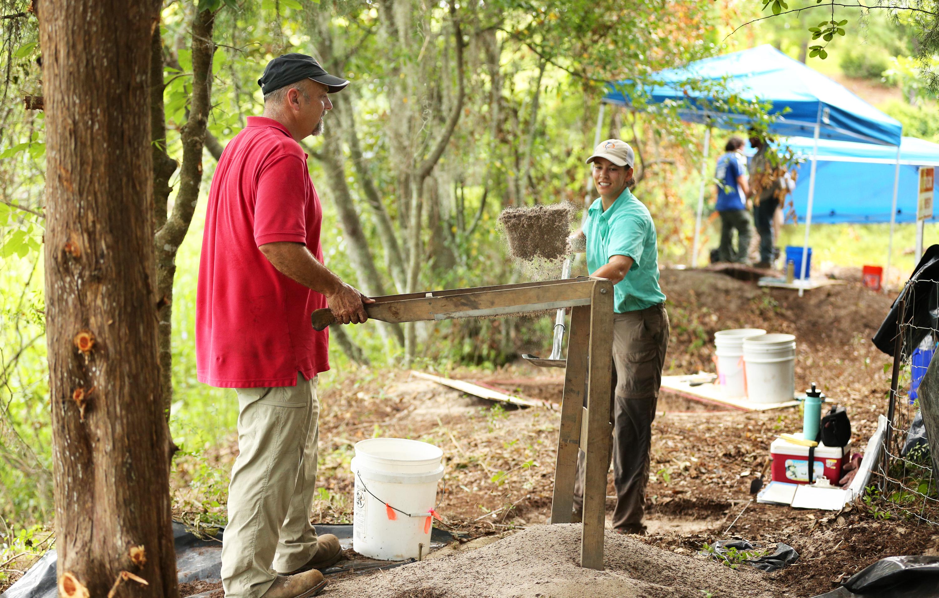 Dr. Philip Carr, Chief Calvin McGhee Endowed Professor, and graduate student Anne Dorland sift soil in search of artifacts. 