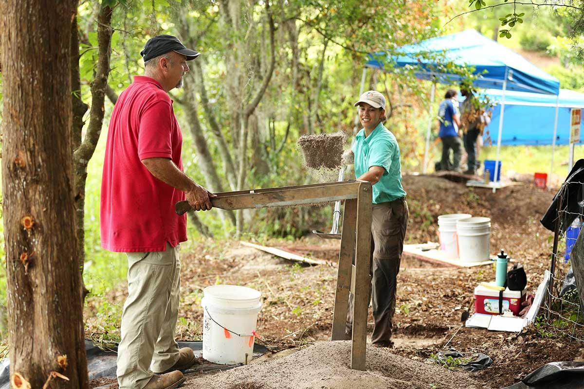 Dr. Philip Carr, Chief Calvin McGhee Endowed Professor, and graduate student Anne Dorland sift soil in search of artifacts. 