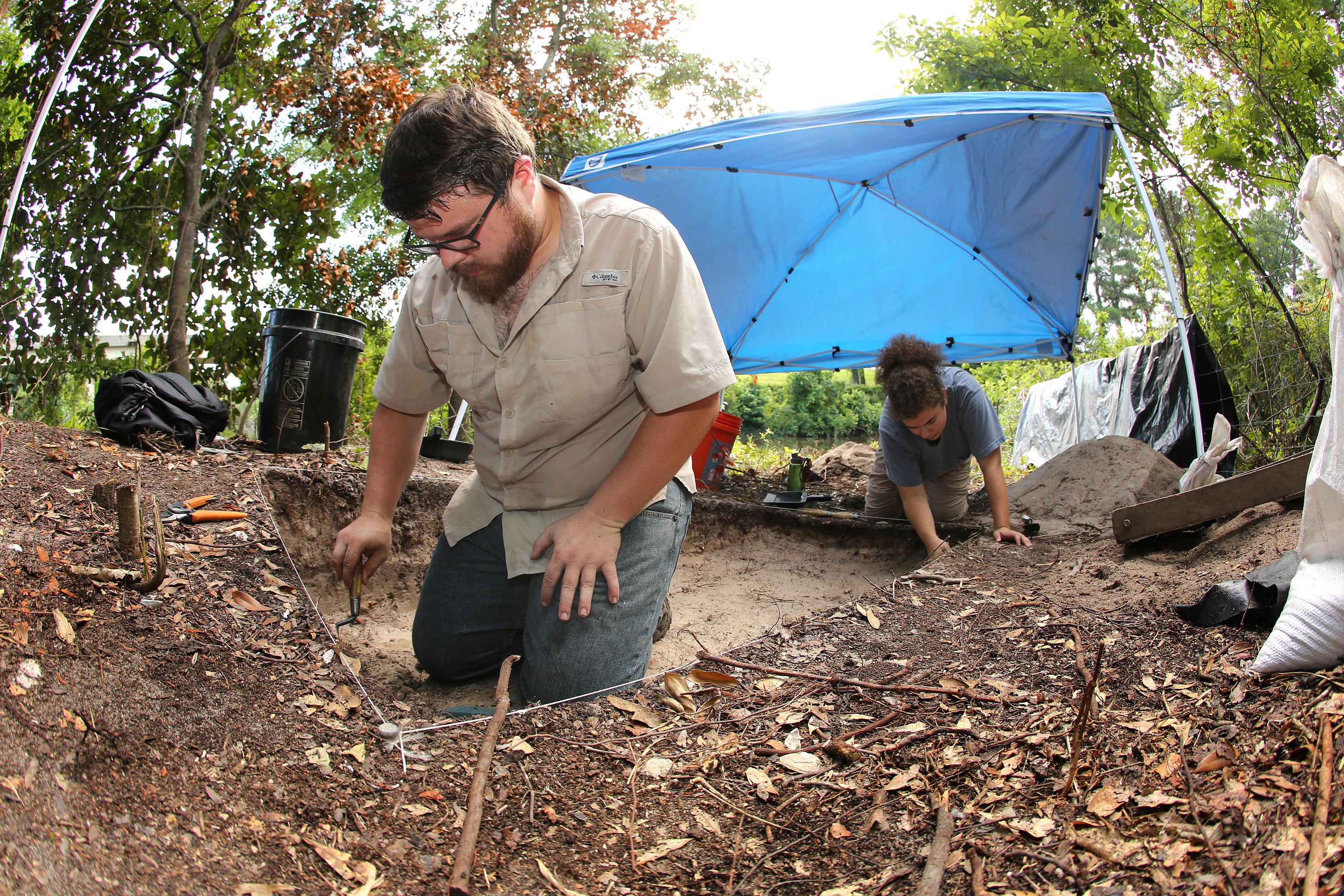 South graduate William Marriott  and student Emily Overmyer work at the excavation site for the proposed Mobile River bridge.