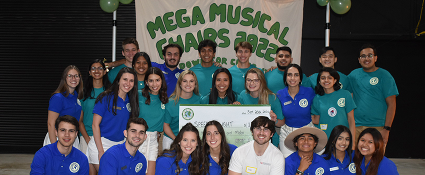 Mega Musical Chairs group picture with check 2022.