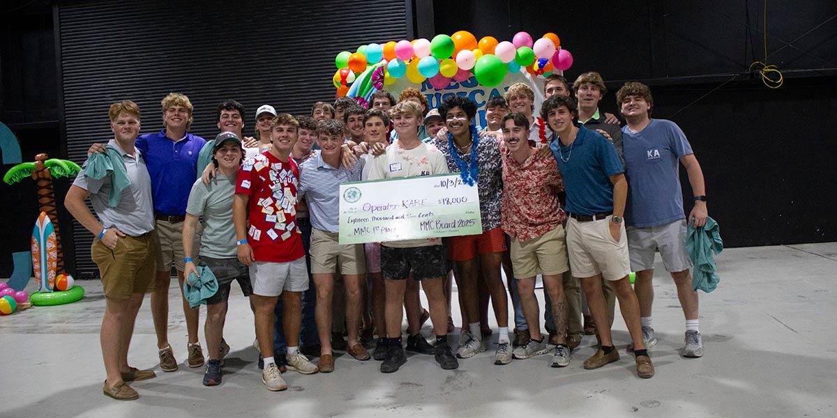 participants holding a large check