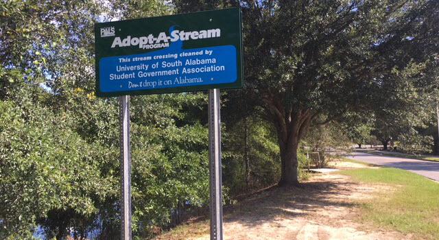 Adopt-A Stream sign placed near the entrance to the Glenn Sebastian Nature Trail by the USA Student Government Association