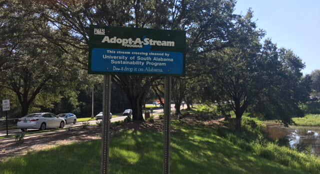 Adopt-A-Stream sign placed on Health Services Drive near the spillway