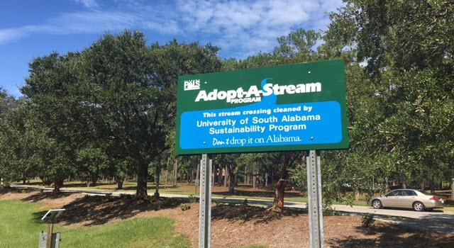 Adopt-A-Stream sign placed on Health Services Drive by the USA Sustainability Program