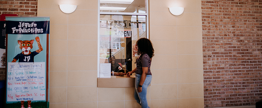 Female student in front of ticket counter