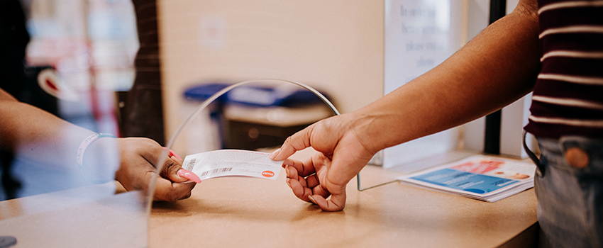 Hands exchanging a ticket