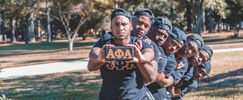 NPHC Students holding up greek sign