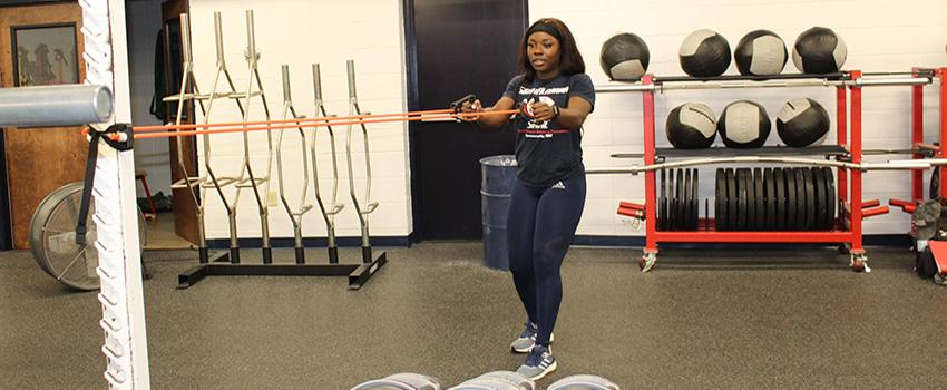 A female student pulling a exercise band