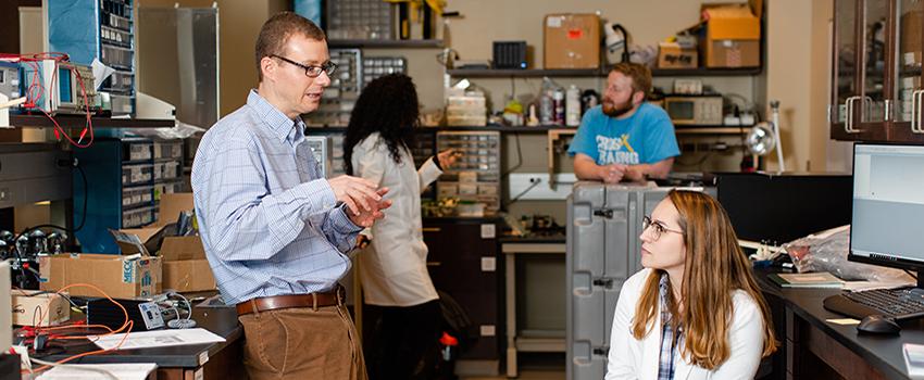 A professor talking to a student in the lab.