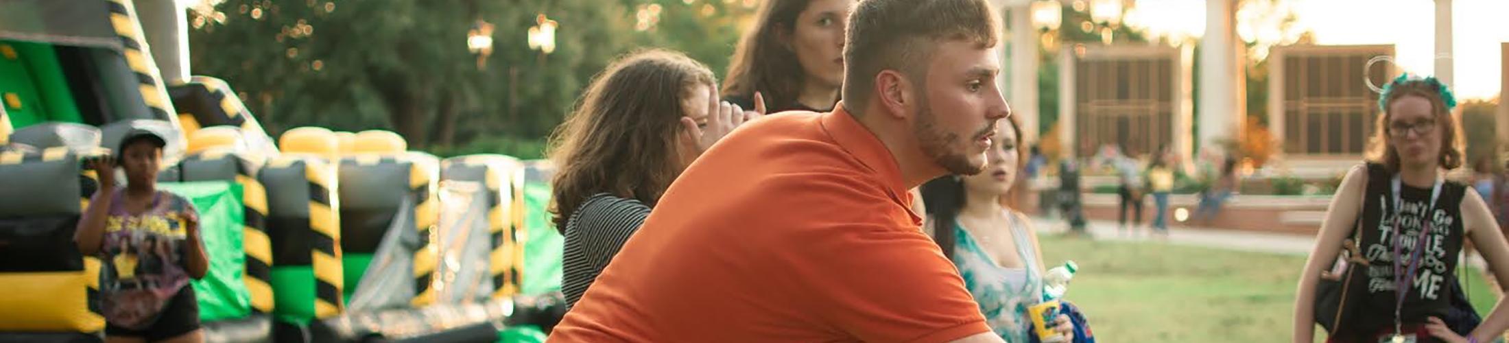 Male student playing cornhole