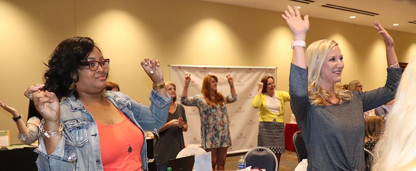 Females holding up hands in workshop