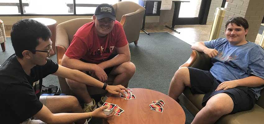 Yusuf, Josh, and Jake playing UNO card game.