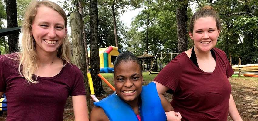 Loren, Timberly, and Lindy at Camp Grace getting ready to kayak.