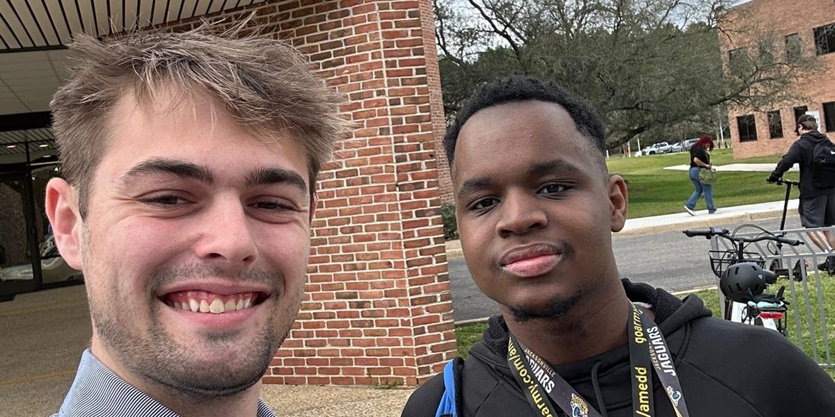 Passage USA student taking a picture with their mentor on campus