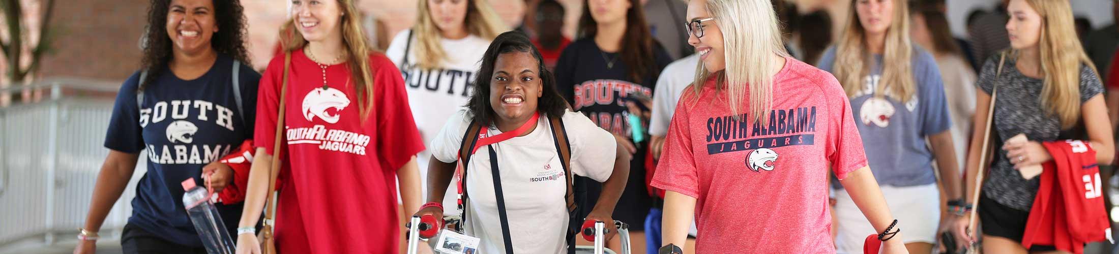 A group of students in South shirts including one using a walker.