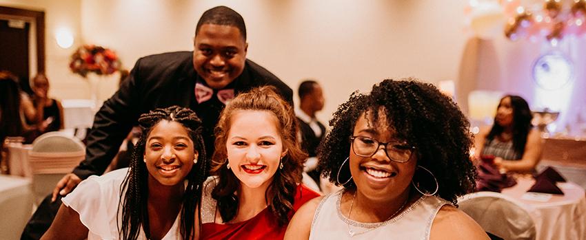 Friends pose for a picture at the banquet