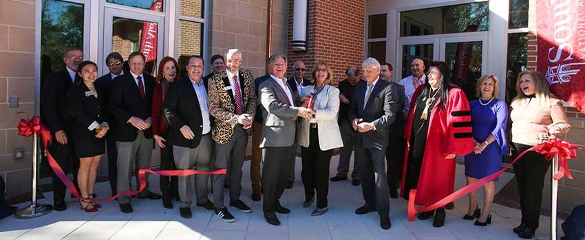 Ribbon Cutting Ceremony in front of Alumni center.