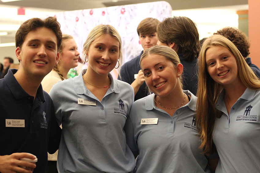 Four FYC members smiling.