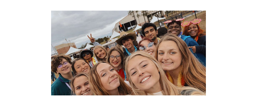 Selfie of group of FYC members at Homecoming game.