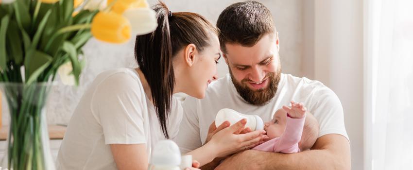 Mother and father feeding a baby