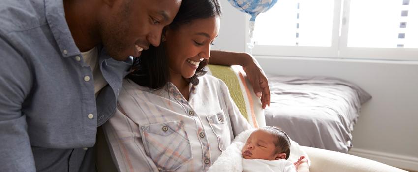 Mother and father looking at their baby