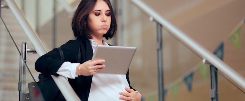 A pregnant woman looking at computer