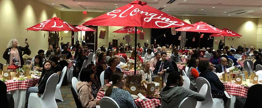 People gathered for luncheon sitting at tables.