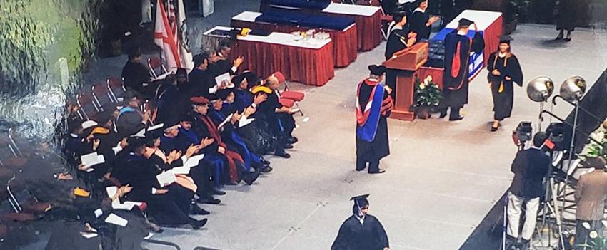 Zafar waking across stage at graduation