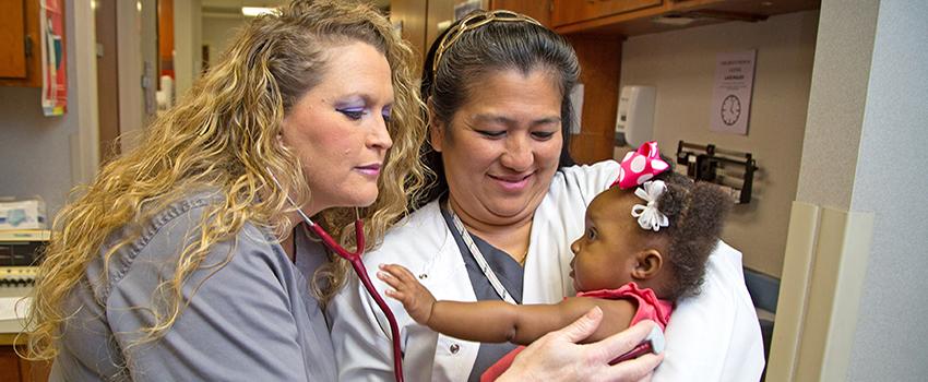 Nurses treating baby