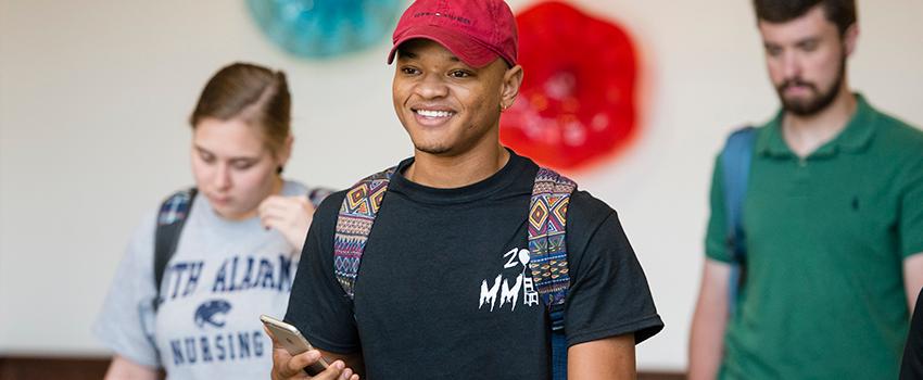 Student smiling walking out of class