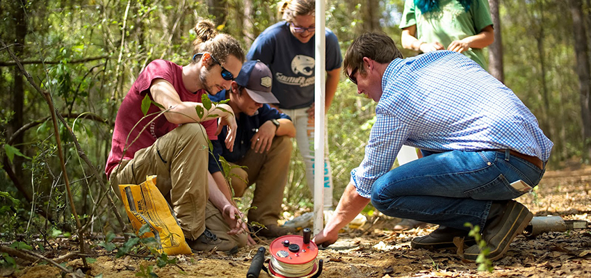 Students working in the field on a project.