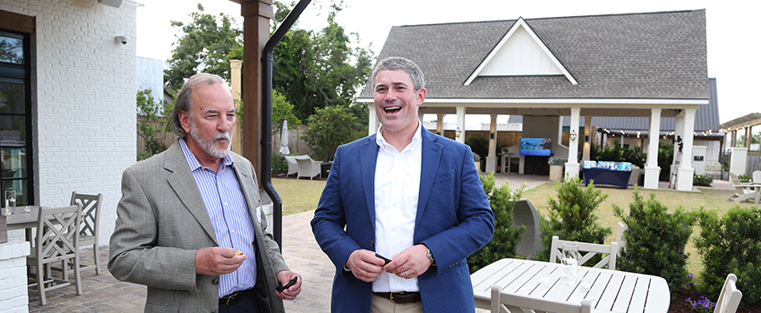 Two men talking at event.