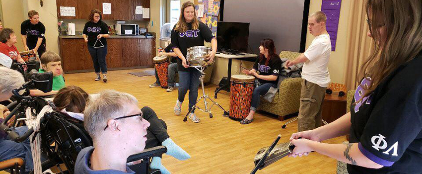 Phi Boota Roota working with musical instruments with people with disabilities.